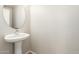 Stylish half-bathroom with a pedestal sink, modern faucet, and clean, bright aesthetics at 3049 W Santa Cruz Ave, San Tan Valley, AZ 85144