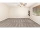 Empty bedroom featuring neutral carpet, walls, and a ceiling fan at 3049 W Santa Cruz Ave, San Tan Valley, AZ 85144