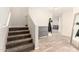 View of the home's entryway featuring the staircase and wood-look tile flooring at 3049 W Santa Cruz Ave, San Tan Valley, AZ 85144