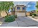 Charming two-story home with a two car garage, desert landscaping, and a cozy front porch at 3049 W Santa Cruz Ave, San Tan Valley, AZ 85144