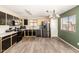 Spacious kitchen featuring stainless steel appliances, dark cabinets and tiled floors at 3049 W Santa Cruz Ave, San Tan Valley, AZ 85144
