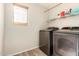 A well-lit laundry room featuring modern appliances and convenient storage at 3049 W Santa Cruz Ave, San Tan Valley, AZ 85144