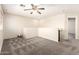 Spacious loft area featuring neutral carpeting and a ceiling fan at 3049 W Santa Cruz Ave, San Tan Valley, AZ 85144