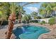 Backyard pool with lush landscaping, rock features, and clear blue water, perfect for relaxation at 3440 E Southern Ave # 1042, Mesa, AZ 85204