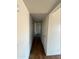 Hallway with white walls and wood look laminate flooring at 3441 W Windrose Dr, Phoenix, AZ 85029