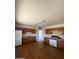 Functional kitchen featuring wood cabinets, white appliances, and laminate flooring at 3441 W Windrose Dr, Phoenix, AZ 85029