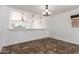 Bright dining room with tile flooring and modern chandelier at 3644 W Maryland Ave, Phoenix, AZ 85019