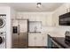 Kitchen features stainless steel appliances, sink, and white cabinetry with marbled countertops at 3644 W Maryland Ave, Phoenix, AZ 85019