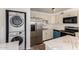 Bright kitchen features stainless steel appliances and marbled countertops, plus a laundry area at 3644 W Maryland Ave, Phoenix, AZ 85019