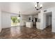 Bright living room leading to the kitchen area and an outdoor patio at 3644 W Maryland Ave, Phoenix, AZ 85019