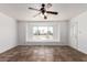 Bright living room with a ceiling fan, tile flooring and lots of natural light at 3644 W Maryland Ave, Phoenix, AZ 85019
