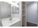 Bathroom with walk in closet and vanity with mirror and vanity lighting at 37053 W Amalfi Ave, Maricopa, AZ 85138