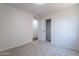 Bedroom boasts carpeted floors, closet and door to adjoining bathroom at 37053 W Amalfi Ave, Maricopa, AZ 85138