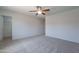 Spacious bedroom featuring neutral carpet, ceiling fan, and a walk-in closet at 37053 W Amalfi Ave, Maricopa, AZ 85138