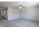 Neutral carpet, and a ceiling fan accent a spacious bedroom in this home at 37053 W Amalfi Ave, Maricopa, AZ 85138