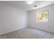 Simple bedroom featuring neutral carpet and natural light from the window at 37053 W Amalfi Ave, Maricopa, AZ 85138