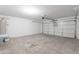 Spacious two-car garage offering ample parking and storage space at 37053 W Amalfi Ave, Maricopa, AZ 85138