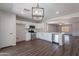 Well-lit kitchen with stainless steel appliances, modern cabinetry, and an open view to the living area at 37053 W Amalfi Ave, Maricopa, AZ 85138