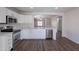 Bright kitchen with stainless steel appliances, white cabinets and long breakfast bar at 37053 W Amalfi Ave, Maricopa, AZ 85138