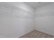 Bright walk-in closet featuring a wire shelving system for organization at 37053 W Amalfi Ave, Maricopa, AZ 85138