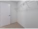 Bright walk-in closet featuring a wire shelving system and a door at 37053 W Amalfi Ave, Maricopa, AZ 85138