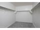 Spacious walk-in closet, featuring carpeted floors, and metal shelving along the walls at 3908 S 98Th Ln, Tolleson, AZ 85353