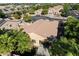 This aerial perspective highlights the property's well-manicured lawn, covered patio, and lush tree coverage at 4032 S Santa Rita Pl, Chandler, AZ 85249
