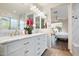 Modern bathroom with dual sinks, marble countertops, stylish lighting, and a view to the main bedroom at 4032 S Santa Rita Pl, Chandler, AZ 85249