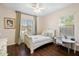 Comfortable bedroom with a twin bed, stylish curtains, desk, and a bright window view at 4032 S Santa Rita Pl, Chandler, AZ 85249