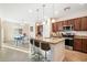 Modern kitchen featuring a granite island with barstool seating and stainless steel appliances at 4032 S Santa Rita Pl, Chandler, AZ 85249