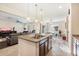 Bright kitchen features a granite countertop island with a stainless steel sink and pendant lighting at 4032 S Santa Rita Pl, Chandler, AZ 85249