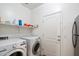 Functional laundry room with washer, dryer, shelving for storage, and convenient access to the side-by-side refrigerator at 4032 S Santa Rita Pl, Chandler, AZ 85249