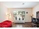 Well-lit living room with stylish vases on a display table, desk, bean bag and a large window at 4032 S Santa Rita Pl, Chandler, AZ 85249