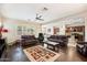 Spacious living room featuring hardwood floors, comfortable seating, and an abundance of natural light at 4032 S Santa Rita Pl, Chandler, AZ 85249