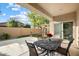 Covered patio features an outdoor dining set overlooking the grass and fence enclosed backyard at 4032 S Santa Rita Pl, Chandler, AZ 85249