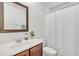 Bathroom with a wood vanity, framed mirror, and shower with curtain at 4159 E Jasper Dr, Gilbert, AZ 85296