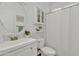 Bright bathroom with a white vanity, marble accent wall, and shower with curtain at 4159 E Jasper Dr, Gilbert, AZ 85296