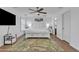 Main bedroom with a TV, ceiling fan, and white furniture at 4159 E Jasper Dr, Gilbert, AZ 85296
