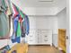 Walk in closet with wood floors, lots of clothing, and built-in shelving at 4159 E Jasper Dr, Gilbert, AZ 85296