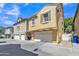 Well-maintained townhouse featuring a two-car garage and neutral stucco at 4159 E Jasper Dr, Gilbert, AZ 85296