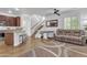 Spacious living area features a kitchen bar, a wooden staircase, and hardwood flooring throughout at 4159 E Jasper Dr, Gilbert, AZ 85296