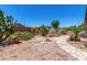 Picturesque backyard with rock features, drought tolerant landscaping, and a decorative stone walkway at 43875 W Baker Dr, Maricopa, AZ 85138