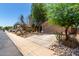 Street view of a single-story home with desert landscaping, a long driveway, and a two-car garage at 43875 W Baker Dr, Maricopa, AZ 85138