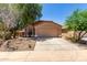 Charming single-story home with a two-car garage, desert landscaping, and a red tile roof at 43875 W Baker Dr, Maricopa, AZ 85138