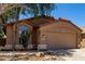 Exterior shot of a single-story home with desert landscaping and a two-car garage at 43875 W Baker Dr, Maricopa, AZ 85138