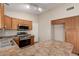 Spacious kitchen with stainless appliances, and wood cabinets at 43875 W Baker Dr, Maricopa, AZ 85138