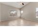 Open-concept living room with tile floors and large windows at 43875 W Baker Dr, Maricopa, AZ 85138