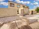 Tan two-story townhome featuring a private gated courtyard and desert landscaping for low maintenance at 4416 E Riverside St, Phoenix, AZ 85040