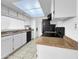 Bright kitchen featuring white cabinets, ample counter space, and modern appliances at 4416 E Riverside St, Phoenix, AZ 85040