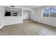 Bright living room features tile flooring, a ceiling fan and ample natural light at 4416 E Riverside St, Phoenix, AZ 85040